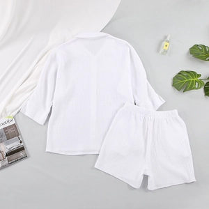 Detailed flat lay of white crinkle cotton pajama set featuring soft textured fabric detail