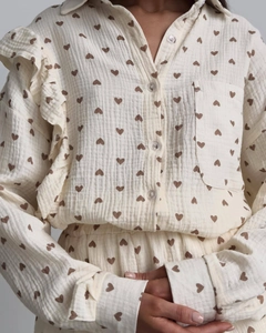 Detail of ruffled shoulders and heart print on cream cotton muslin loungewear set