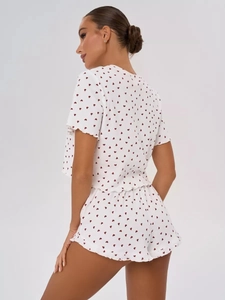 Detail view of the ruffle trim and heart print on white short sleeve pajama set back