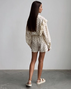 Rear view of cream ruffle loungewear set featuring brown heart patterns and textured cotton fabric