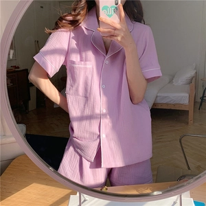 Detail of purple cotton gauze pajamas with button-down shirt and matching shorts
