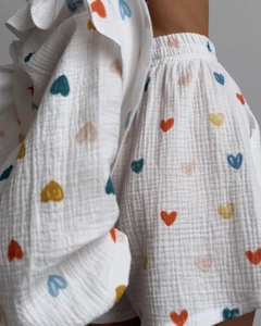 Detail view of cotton gauze loungewear with colorful heart print and ruffle accents