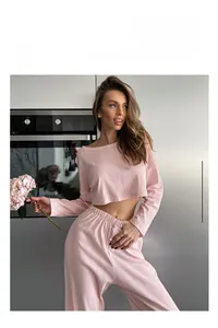 Detail of pink ribbed knit texture on long sleeve lounge top and high-waist pants