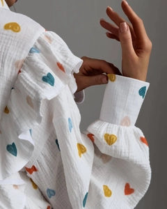 Detail view of cotton gauze loungewear set featuring ruffle shoulders and heart print
