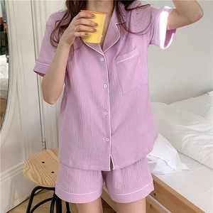 Detail of light purple gauze pajamas with white piping and textured cotton fabric