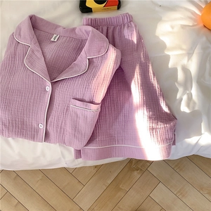 Detail of purple cotton gauze pajama set showing soft textured fabric and white piping