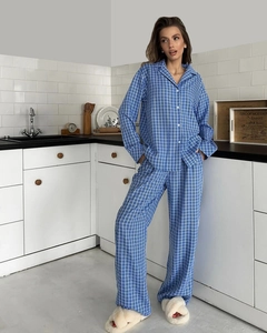 Detail of blue and white plaid pajama set featuring button-up shirt and straight pants