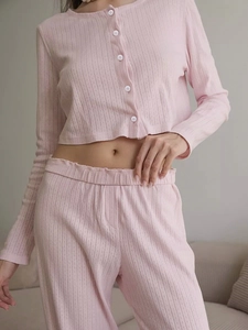 Close-up of pink ribbed knit loungewear set featuring white buttons and soft texture