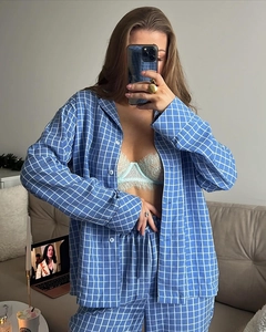 Detail of blue and white checkered pajama set with white buttons and lace trim camisole