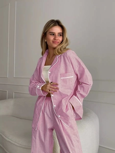 Detail of pink gingham pajama set featuring white piping and button-down lapel collar
