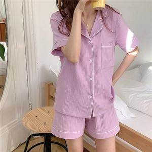Close-up of lavender gauze pajama set showing textured cotton fabric and white piping trim