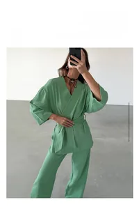 Detail of emerald green cotton pajama set with V-neck wrap top and wide-leg trousers