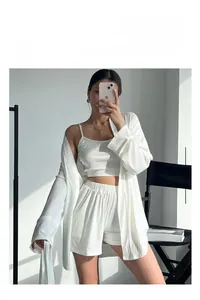 Detail view of white ribbed knit 3-piece lounge set with camisole, shorts, and cardigan