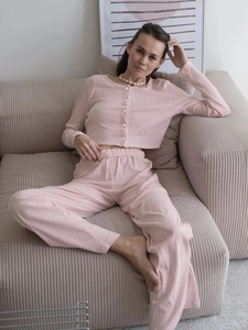 Detail view of pink ribbed knit texture and white buttons on long sleeve pajama set