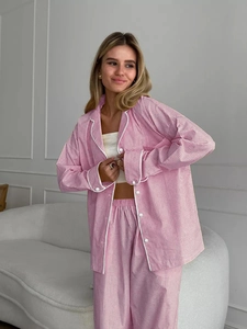 Close-up of pink gingham pajama set featuring notched lapel and white contrast piping