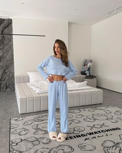Light blue ribbed knit loungewear set with long sleeve top and shorts in a bedroom setting