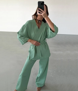 Detail of sage green cotton pajama set with textured crepe fabric and kimono style tie