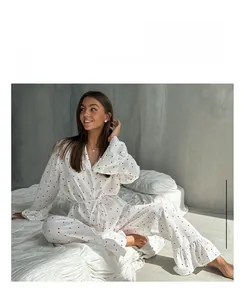 Detail view of heart-print cotton pajama set with elegant ruffled sleeves and hem