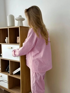 Detail of pink plaid pajama set showing soft cotton fabric and relaxed fit on model