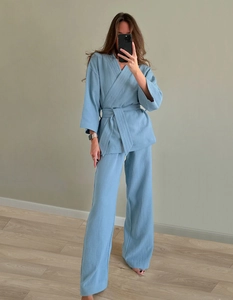 Detail view of light blue cotton pajamas with wrap V-neck and textured fabric detail