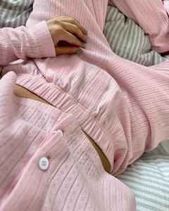 Detail of pink knit loungewear set featuring soft scalloped texture and white buttons