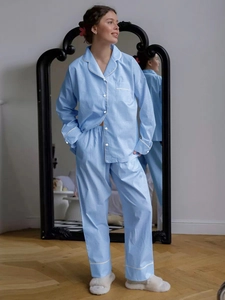 Detail view of light blue checkered pajama set with small buttons and front pocket