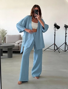 Detail of light blue crinkle gauze cotton pajama set featuring long sleeves and wide-leg pants