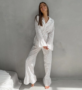 Detail of white cotton pajama sleeve with red heart print and ruffled hem decorative cuffs