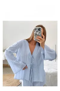 Close-up of light blue cotton pajama set with vertical textures and chic tie-front details