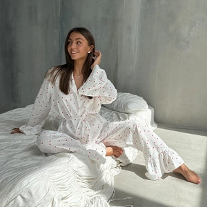 Close-up of white cotton pajamas with red heart prints and ruffled hem details
