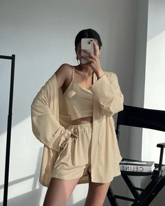 Three-piece beige ribbed knit lounge set featuring a long sleeve cardigan and shorts