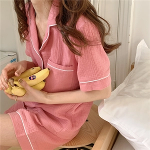Detail of pink cotton gauze pajama set with contrast piping and soft texture