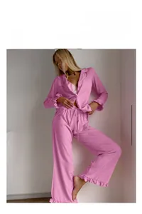 Close-up of pink ruffle pajamas featuring soft knit fabric and detailed lettuce edge hem