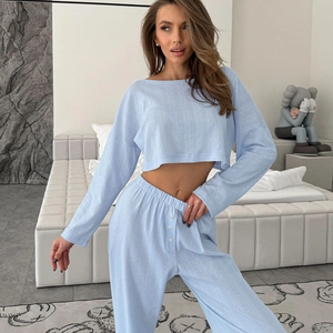 Women's light blue two-piece lounge set with cropped long sleeve top and high-waist pants