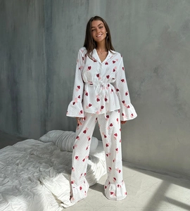 Detail of white cotton heart print pajama set featuring ruffle trim and waist tie design
