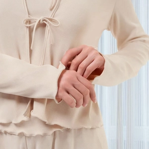 Set pigiama tre pezzi in maglia beige con bordi a volant e cardigan con laccetti