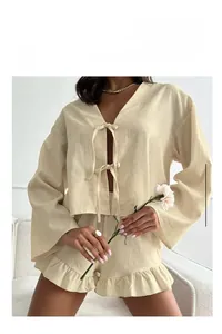 Close-up of cream long sleeve V-neck tie-front top with ruffle shorts loungewear set