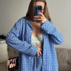 Women's blue and white plaid pajama set with long sleeve button-up top and long pants