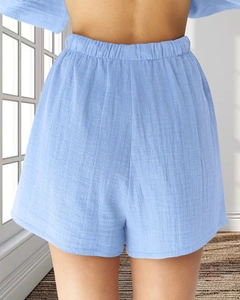 Détail du short en coton bleu clair montrant la texture taille haute et la ceinture