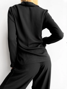 Rear view of black satin lounge set showing the elegant drape and smooth silky texture