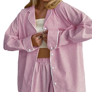 Women's pink gingham pajama set featuring long-sleeve button-down shirt and trousers