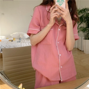 Detail showing the pink gauze texture and white piping of the short-sleeved pajamas set