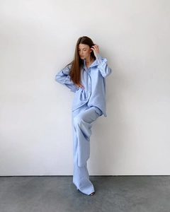 Detail of light blue cotton pajama set showing texture of button-down shirt and wide-leg pants