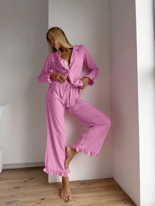 Close-up of pink ruffled pajamas featuring soft fabric and delicate lettuce edge details