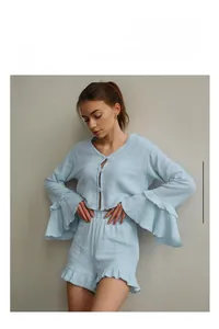 Detail of light blue cotton pajama set with ruffle cuffs and soft crepe texture fabric