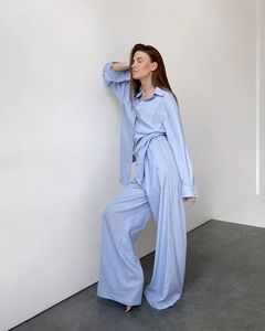 Detailed texture of breathable blue cotton fabric on women's loose pajama shirt
