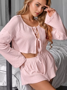 Close-up of pink waffle texture fabric on long-sleeve pajama top and shorts set
