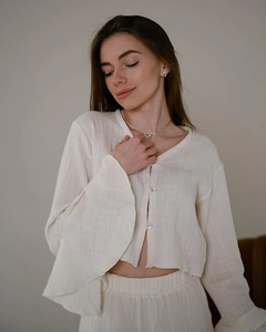 Detail of ruffle sleeve cuffs and textured breathable cotton fabric on pajama set