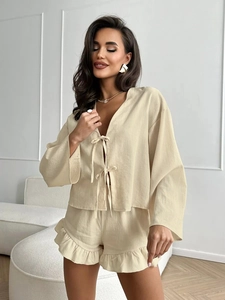 Detail of light beige loungewear set with tie-front cardigan and ruffled hem shorts
