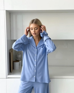 Close-up of sky blue chiffon pajama set featuring white buttons and a chest pocket